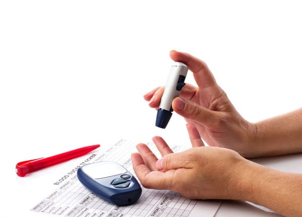 diabetic concept - woman's hands, glucometer, medicine form and pen on white background with place for your text